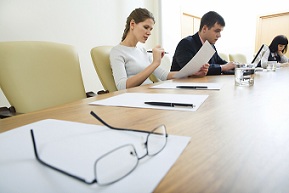 Image of glasses with paper 5500 form on the table on the background of people